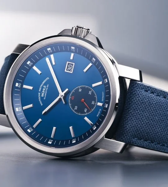 29er Big Small Seconds with blue dial and blue canvas strap lies on its side on a grey background