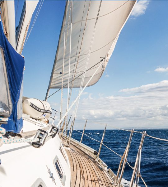 Section of a sailing ship on the sea with a blue sky